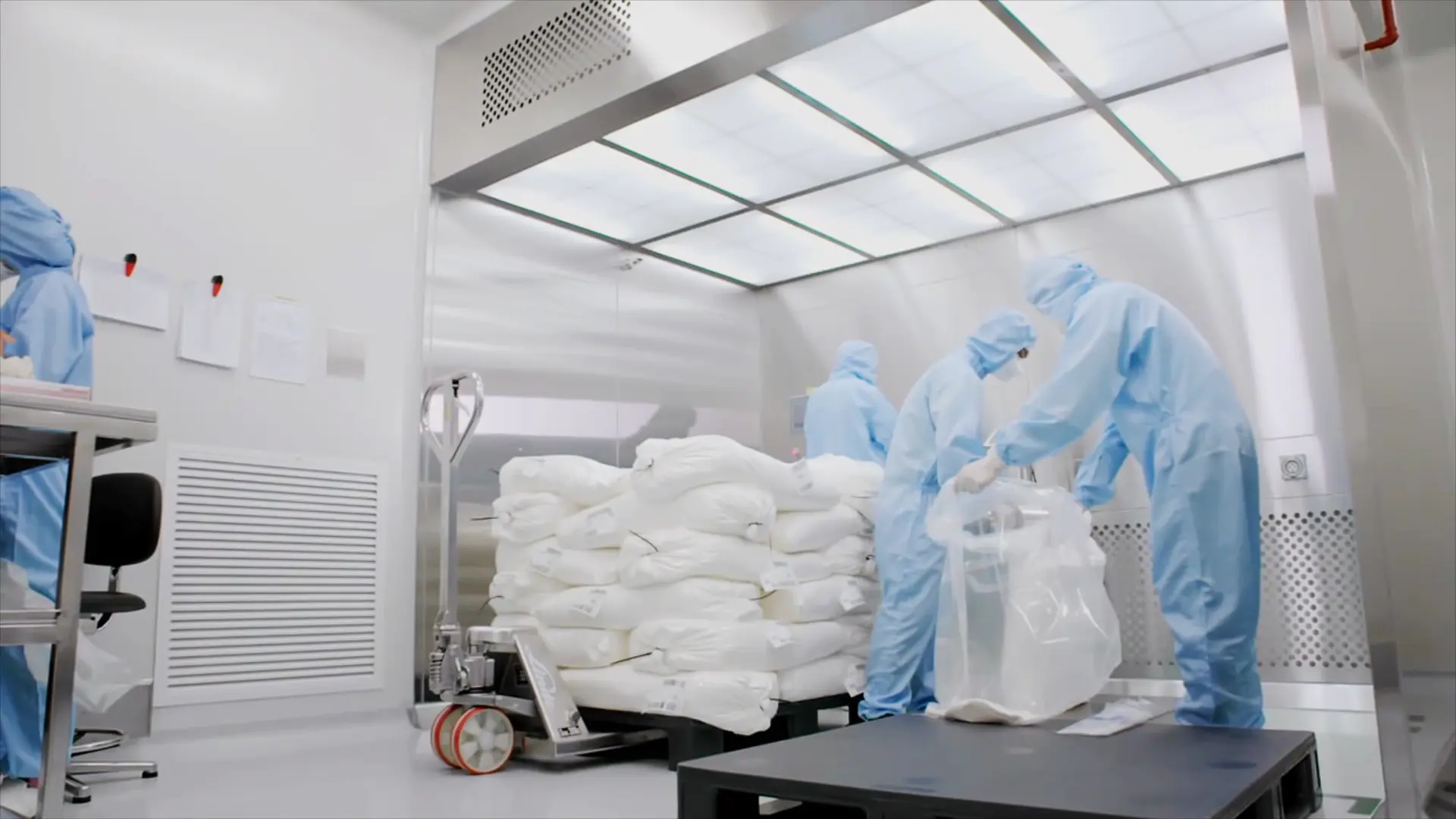 Cleanroom operators handling materials before cosmetic manufacturing